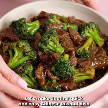 Delicious beef and broccoli stir-fry on a plate, garnished with sesame seeds.
