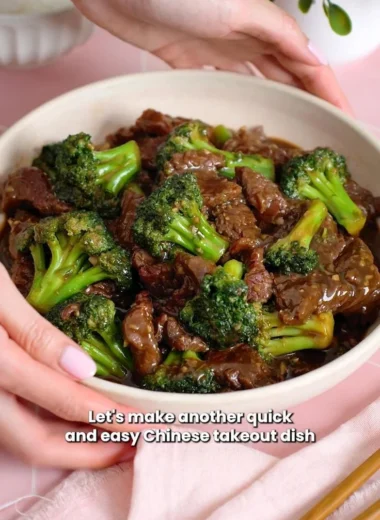 Delicious beef and broccoli stir-fry on a plate, garnished with sesame seeds.