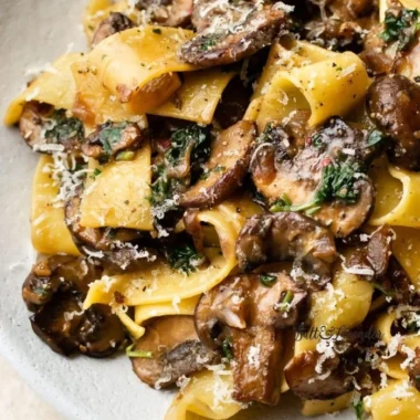 Delicious garlic mushroom pasta dish served in a bowl with herbs