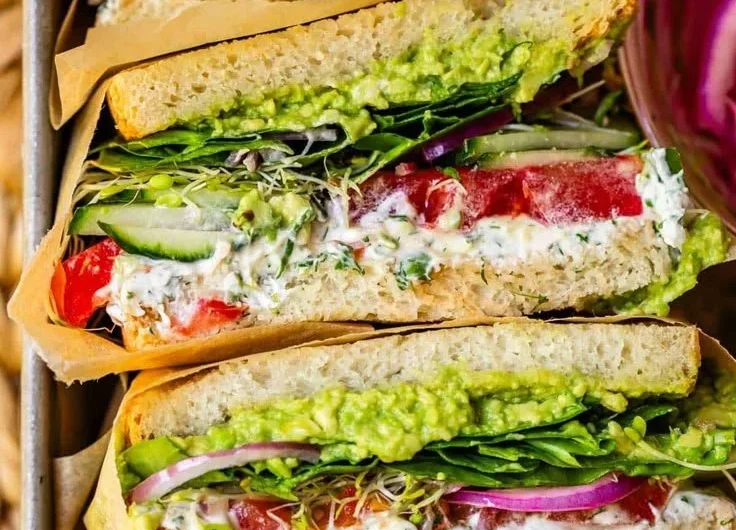 Laura's Amazing Fresh Veggie Sandwich with colorful vegetables and fresh ingredients
