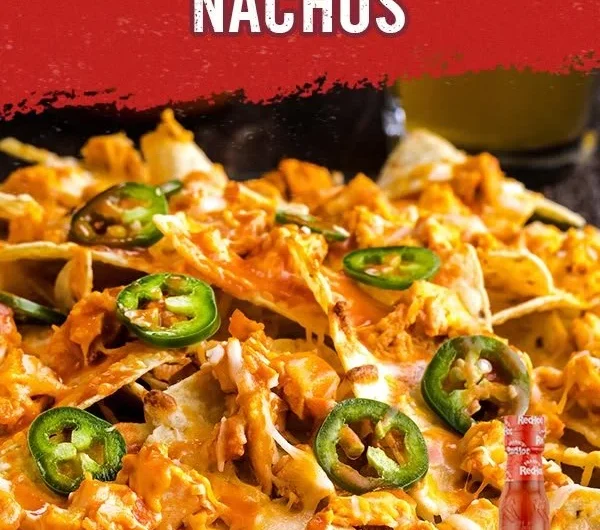 Delicious Buffalo Chicken Nachos topped with cheese and garnishes