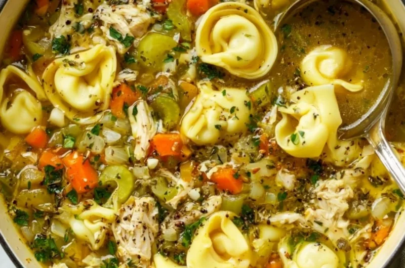 Delicious bowl of Chicken Tortellini Soup topped with herbs and ingredients