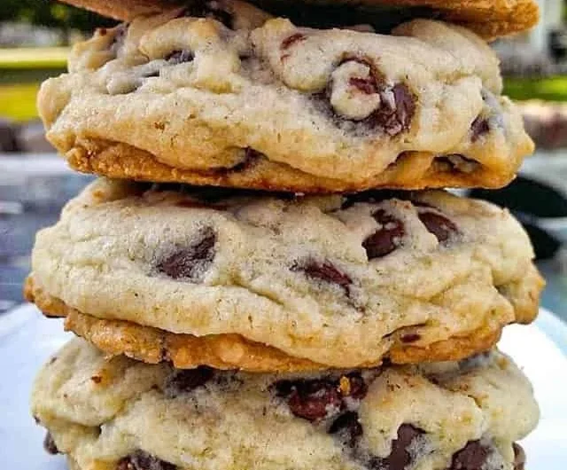 Freshly baked chocolate chip cookies on a cooling rack