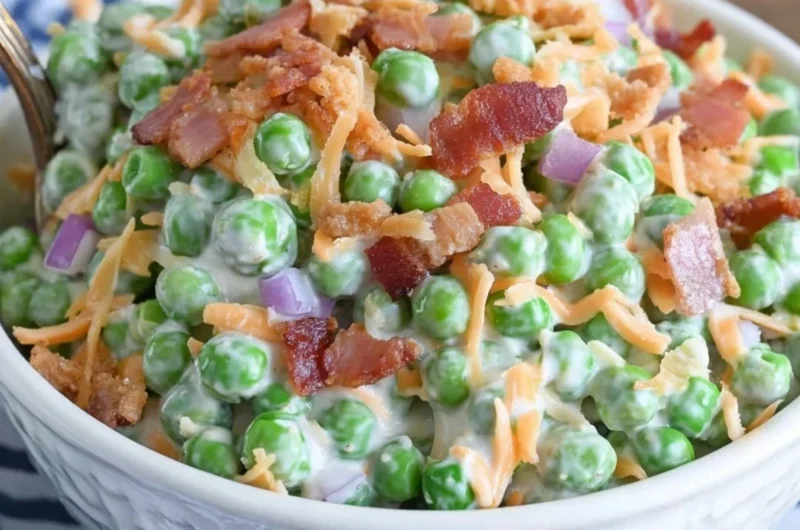 Bowl of classic pea salad with bacon, showcasing fresh peas and vibrant ingredients.