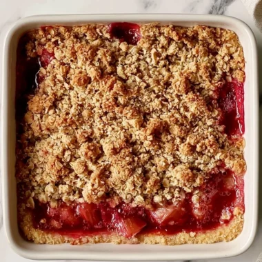 Delicious classic rhubarb crumble bars on a rustic wooden table