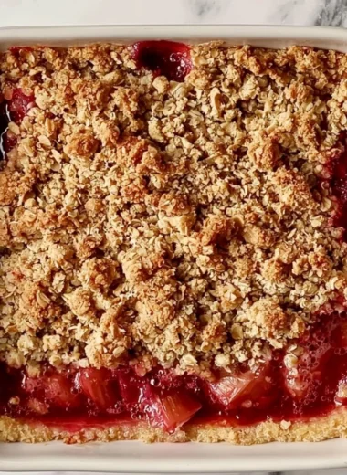 Delicious classic rhubarb crumble bars on a rustic wooden table