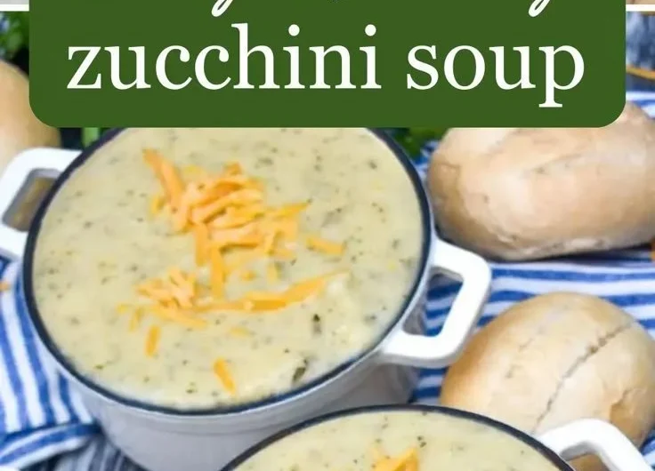Creamy zucchini soup in a bowl garnished with fresh herbs