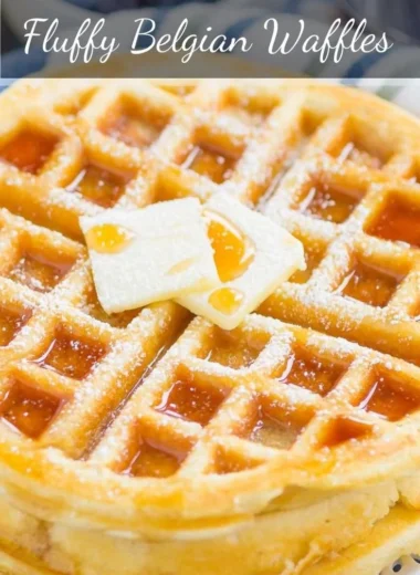 Delicious fluffy Belgian waffles topped with syrup and berries