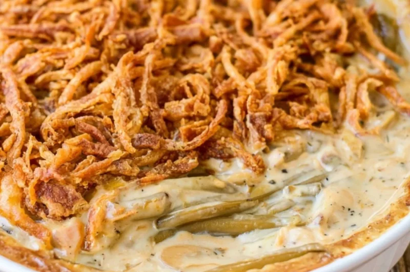 Delicious green bean casserole with crispy onion topping