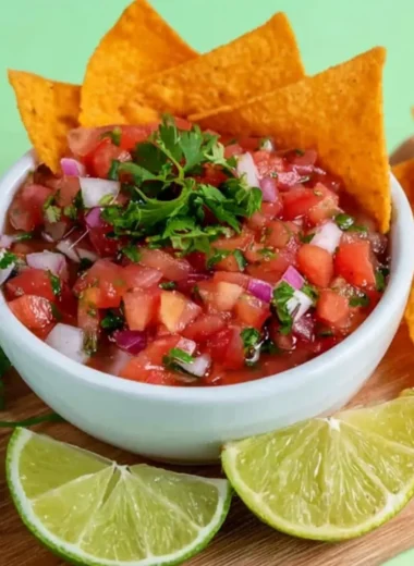 A bowl of fresh homemade salsa with tomatoes, onions, and cilantro