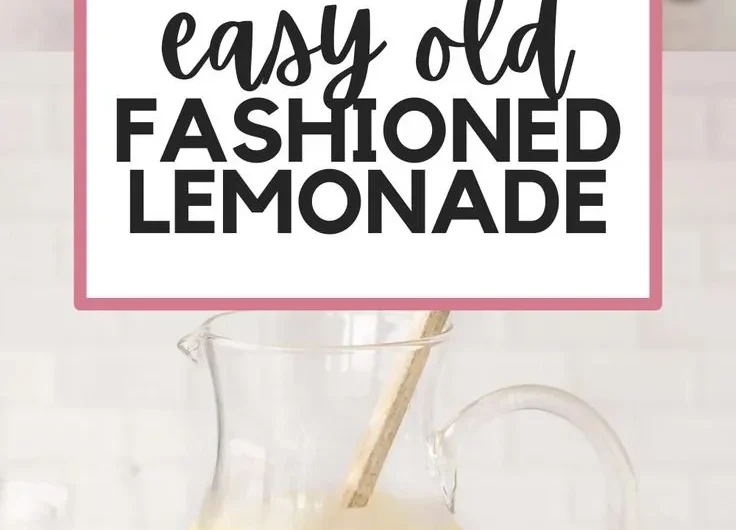 Pitcher of homemade lemonade with fresh lemons and mint leaves
