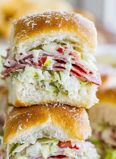 Italian Grinder Sliders stacked with fresh ingredients on a platter
