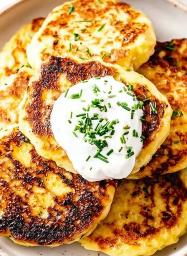 Leftover mashed potato cakes served on a plate with garnish