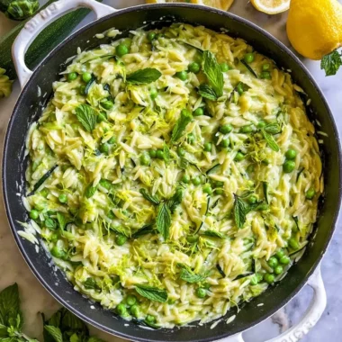 Delicious lemon orzo with zucchini on a plate garnished with herbs