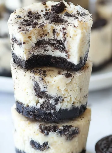 Delicious mini Oreo cheesecakes topped with crushed Oreo cookies.