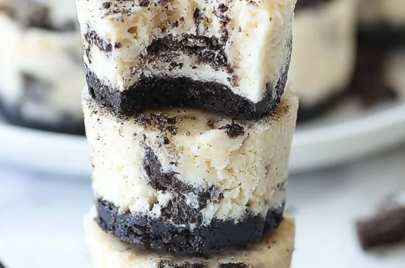 Delicious mini Oreo cheesecakes topped with crushed Oreo cookies.