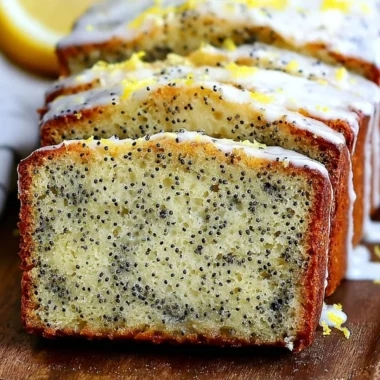 Moist lemon poppy seed bread sliced on a wooden board