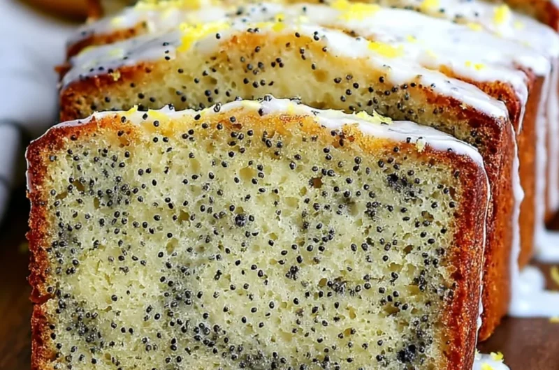 Moist lemon poppy seed bread sliced on a wooden board