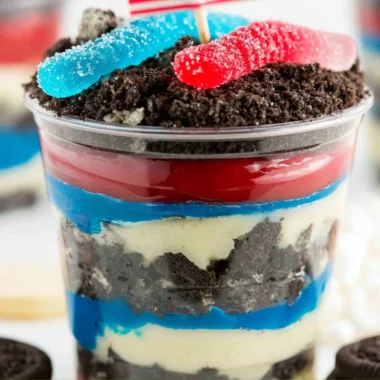 Red, White and Blue Dirt Cups dessert with layered colors and toppings