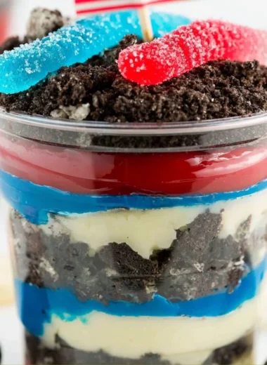 Red, White and Blue Dirt Cups dessert with layered colors and toppings