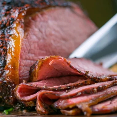 Deliciously smoked roast beef served with sides on a wooden platter
