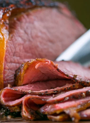 Deliciously smoked roast beef served with sides on a wooden platter