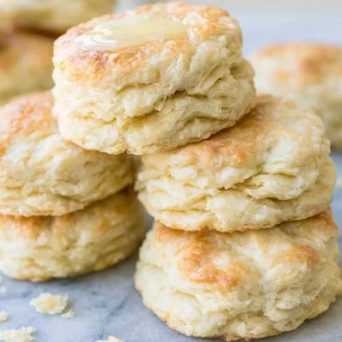Delicious freshly baked biscuits on a rustic wooden table.