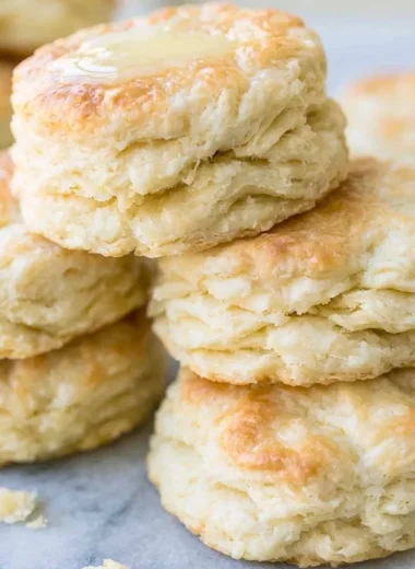 Delicious freshly baked biscuits on a rustic wooden table.