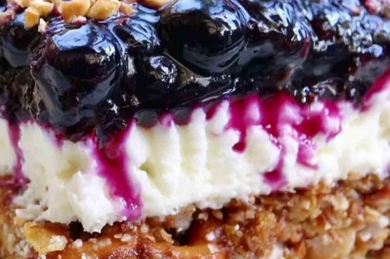 Delicious Blueberry Pretzel Salad with creamy topping and crunchy pretzel crust.