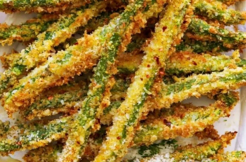 Crispy breaded air fryer asparagus on a plate.
