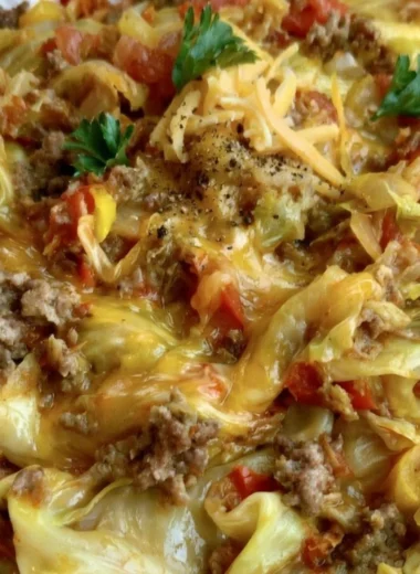 Cabbage Roll Skillet with savory filling and topped with cheese, served on a plate.