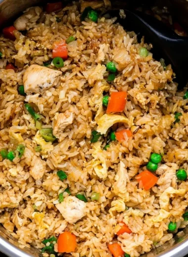 Delicious cozy Instant Pot chicken fried rice served in a bowl with vegetables.