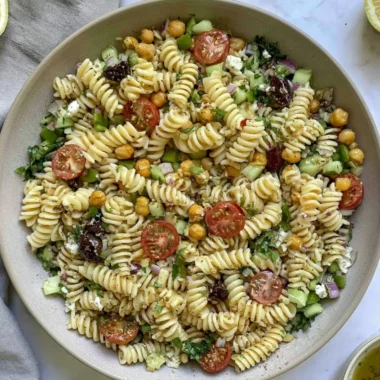 Cozy Vegan Greek Pasta Salad with fresh veggies and herbs in a bowl