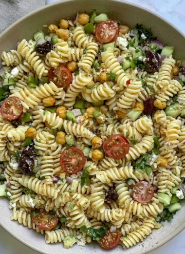 Cozy vegan Greek pasta salad served in a bowl with fresh vegetables