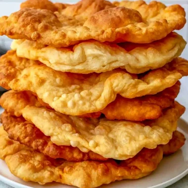 Homemade fry bread served with toppings on a rustic table
