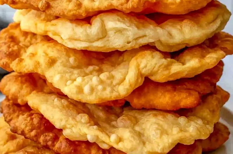 Homemade fry bread served with toppings on a rustic table