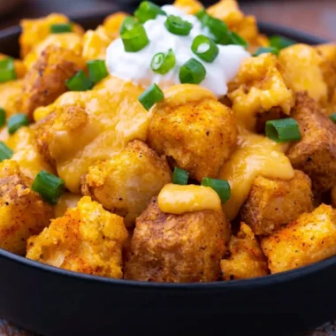 Taco Bell Fiesta Potatoes with cheese and toppings served in a bowl