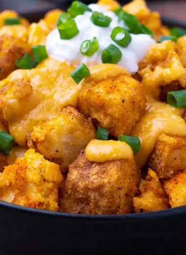 Taco Bell Fiesta Potatoes with cheese and toppings served in a bowl