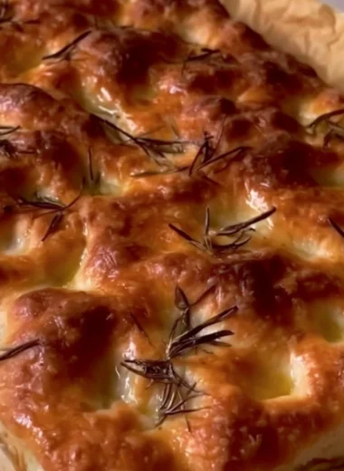 Homemade sourdough focaccia bread topped with herbs and olive oil
