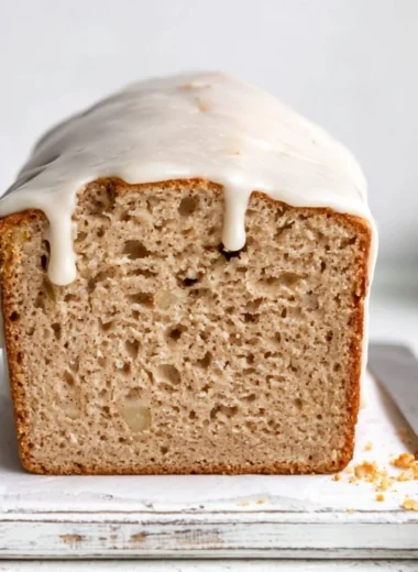 Cozy apple spice cake with cinnamon and fresh apples served on a rustic plate.