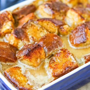 Delicious homemade bread pudding served warm with a drizzle of caramel sauce.