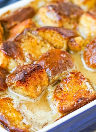 Delicious homemade bread pudding served warm with a drizzle of caramel sauce.