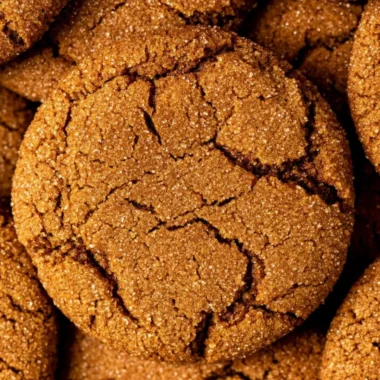 Cozy gingersnap cookies on a plate, topped with sugar and spices.